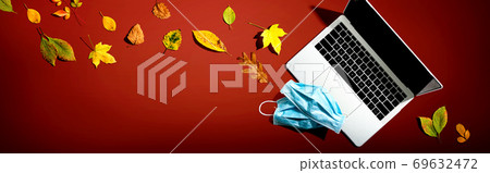 Laptop computer with masks in autumn Laptop computer with masks in autumn 69632472