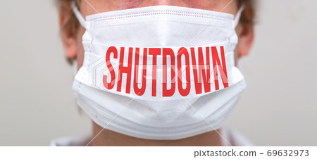 Shutdown theme with person wearing a protective face mask Shutdown theme with person wearing a protective face mask 69632973