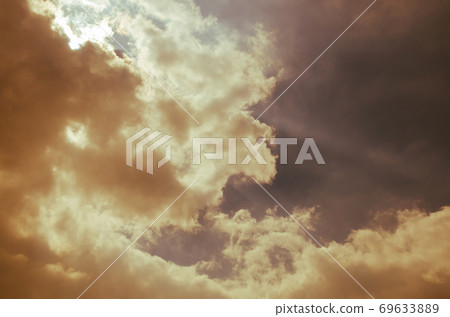 Sunlight Shining Through the Cloud in Warm Color Theme. Sunlight Shining Through the Cloud in Warm Color Theme. 69633889