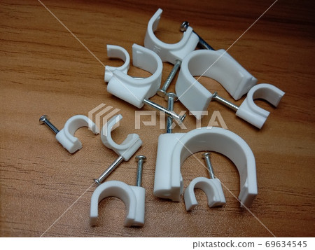 white colored wire pin on wooden table 69634545