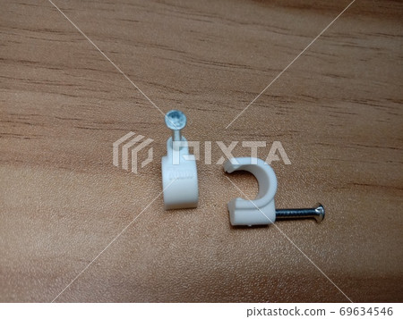 white colored wire pin on wooden table 69634546