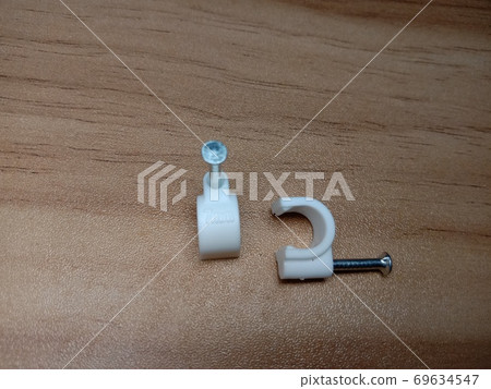 white colored wire pin on wooden table 69634547