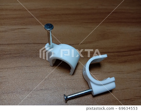 white colored wire pin on wooden table white colored wire pin on wooden table 69634553