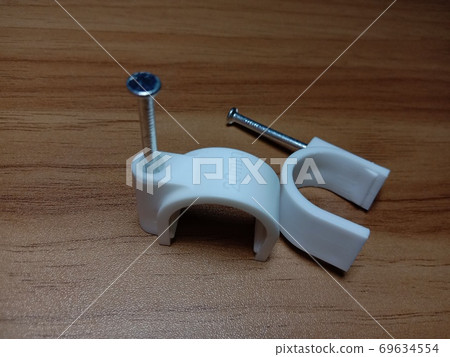 white colored wire pin on wooden table 69634554