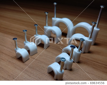 white colored wire pin on wooden table 69634556