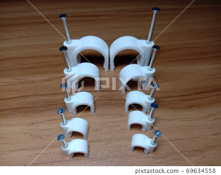 white colored wire pin on wooden table 69634558