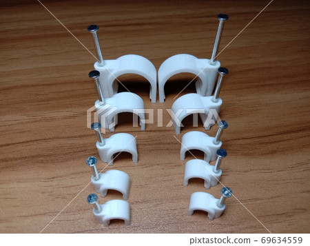 white colored wire pin on wooden table white colored wire pin on wooden table 69634559