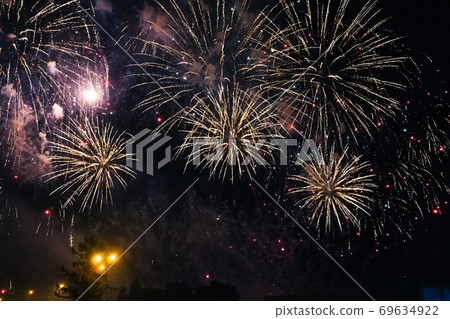 Festive colored fireworks on background a night sky Festive colored fireworks on background a night sky 69634922