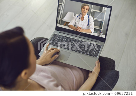Smiling doctor therapist consulting man patient online from laptop Smiling doctor therapist consulting man patient online from laptop 69637231