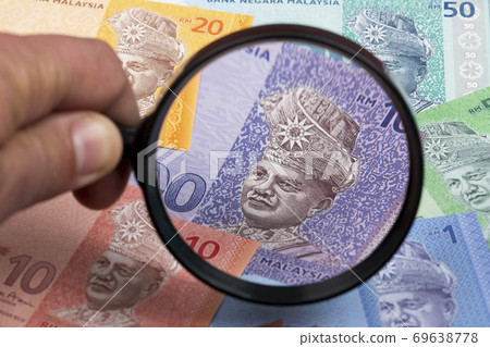 Malaysian money in a magnifying glass a business background 69638778