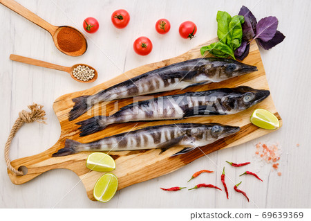 Top view of fresh icefish on wooden cutting board Top view of fresh icefish on wooden cutting board 69639369