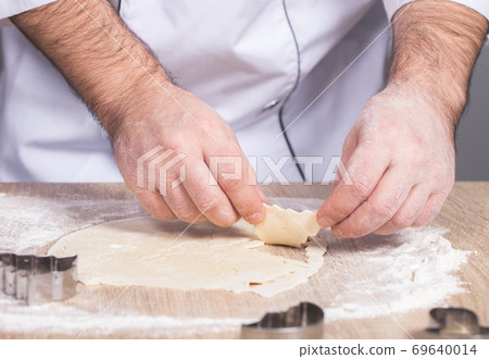 male cook preparing Christmas cookies 69640014