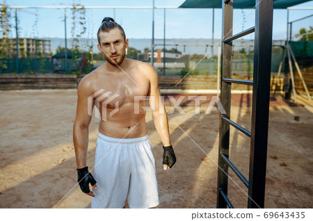 Athletic man with muscular body, street workout 69643435