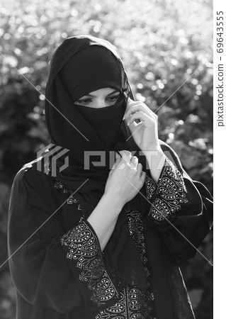 A migrant woman from the east in black clothes. 69643555