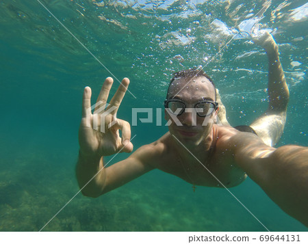 man swims under water 69644131