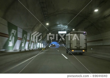 A car running through a tunnel A car running through a tunnel 69644840