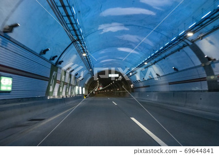 A car running through a tunnel A car running through a tunnel 69644841