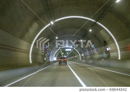 A car running through a tunnel A car running through a tunnel 69644842