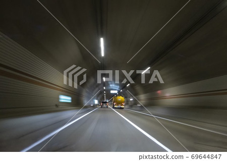 A car running through a tunnel A car running through a tunnel 69644847