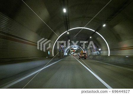 A car running through a tunnel A car running through a tunnel 69644927