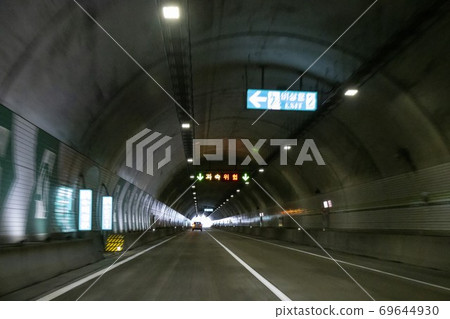 A car running through a tunnel A car running through a tunnel 69644930