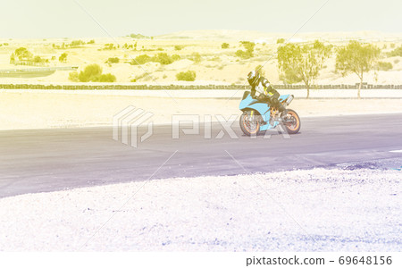 motorcycle racer rides on a sports track 69648156