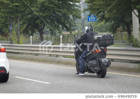 Rider running on the road 69649059