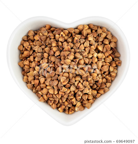 buckwheat groats in heart shaped plate 69649097