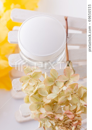 white cosmetics container and hydrangea inflorescence on a white background. Health, body care white cosmetics container and hydrangea inflorescence on a white background. Health, body care 69650555