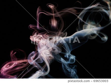 Colorful smoke curve on black background Colorful smoke curve on black background 69653003