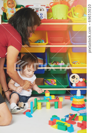 Woman take care of baby Woman take care of baby 69653010