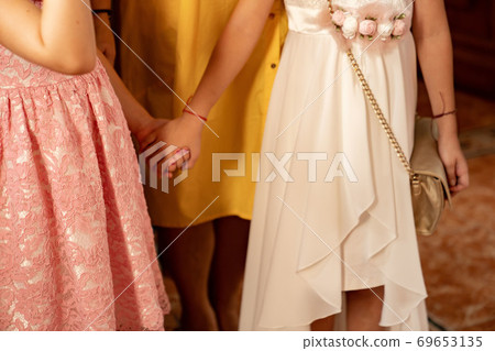 guests wedding without faces hold hands in Church. guests wedding without faces hold hands in Church. 69653135