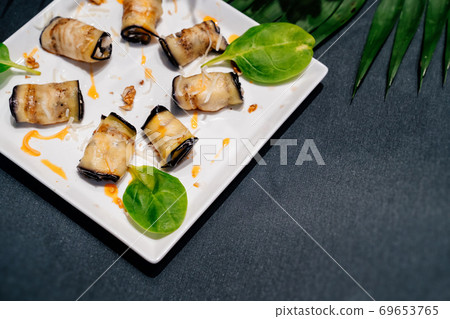 eggplant appetizer in white plate on a black table eggplant appetizer in white plate on a black table 69653765