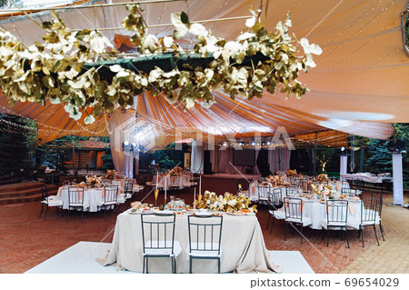 Wedding decor. tables in outdoor tent evening. Wedding decor. tables in outdoor tent evening. 69654029