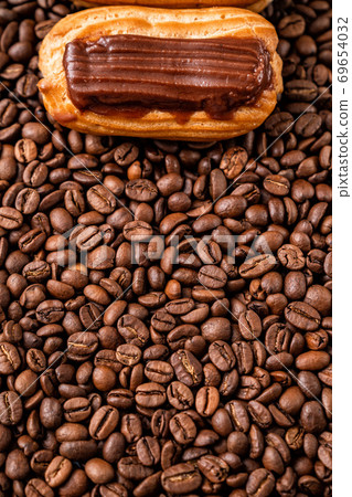one cake with chocolate icing on coffee. one cake with chocolate icing on coffee. 69654032