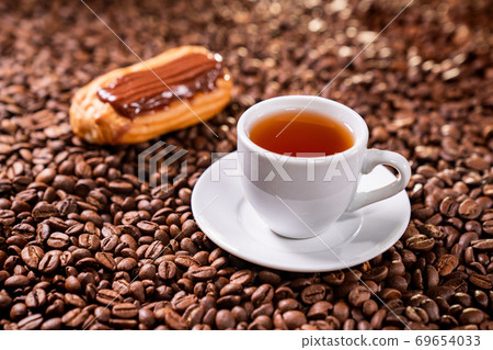 tea, custard cake, on background coffee beans tea, custard cake, on background coffee beans 69654033