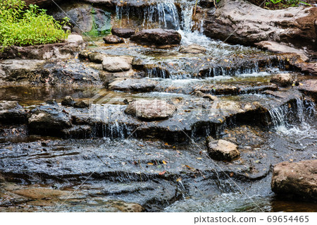 Water running over rocks 69654465