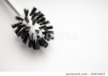 a toilet brush on a white background. close-up. a toilet brush on a white background. close-up. 69654607