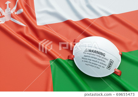 Coronavirus medical surgical face mask on the Omani national flag Coronavirus medical surgical face mask on the Omani national flag 69655473