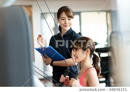 Woman training with an instructor Woman training with an instructor 69656151