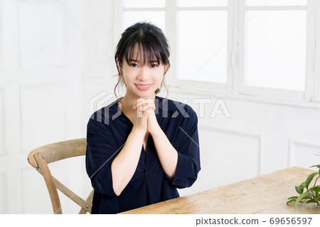Young woman making a request gesture 69656597