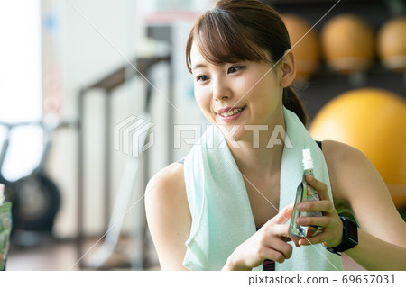 Women feeding at a sports gym Women feeding at a sports gym 69657031