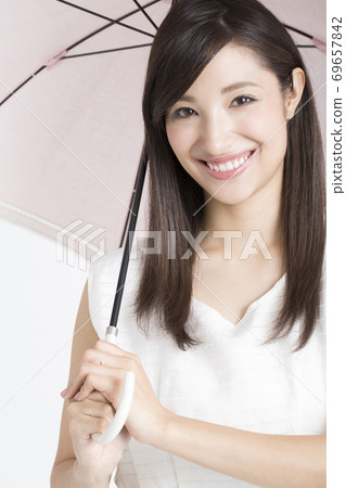A woman holding an umbrella A woman holding an umbrella 69657842