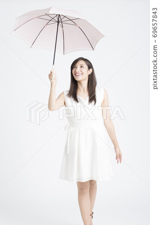 A woman holding an umbrella A woman holding an umbrella 69657843