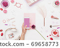 Smartphone in woman hand above artist workplace 69658773