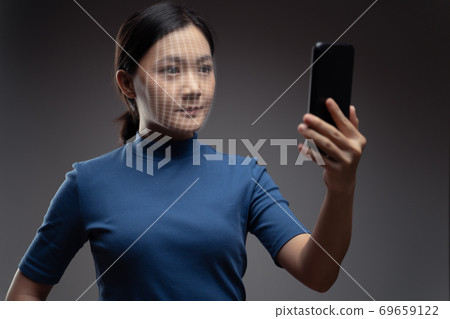 Asian woman scans face by smart phone 69659122