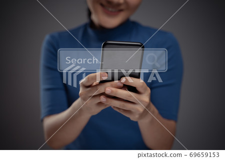 Asian woman using smart phone for searching with browser icon hologram effect. Asian woman using smart phone for searching with browser icon hologram effect. 69659153