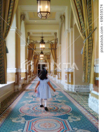 Children toddling in a beautifully decorated hotel corridor Children toddling in a beautifully decorated hotel corridor 69659574