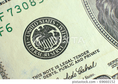 Closeup federal reserve symbol on dollar banknote 69660152