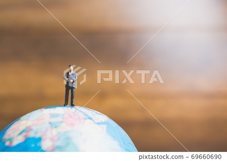 Miniature people , businessman  standing on the globe world map Miniature people , businessman  standing on the globe world map 69660690